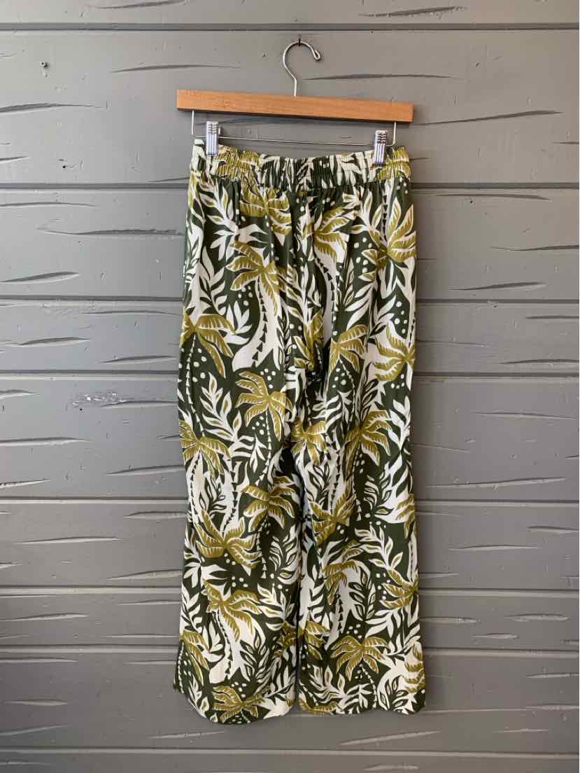 High-waist tropical print pants with olive green, white, and beige leafy pattern, lightweight fabric.