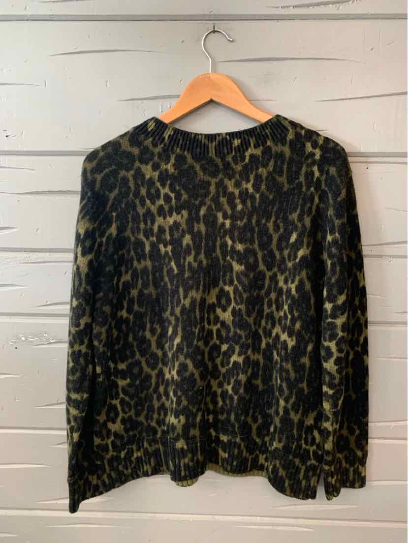 Long-sleeve petite sweater in black and brown cheetah print with crew neckline on wooden hanger.