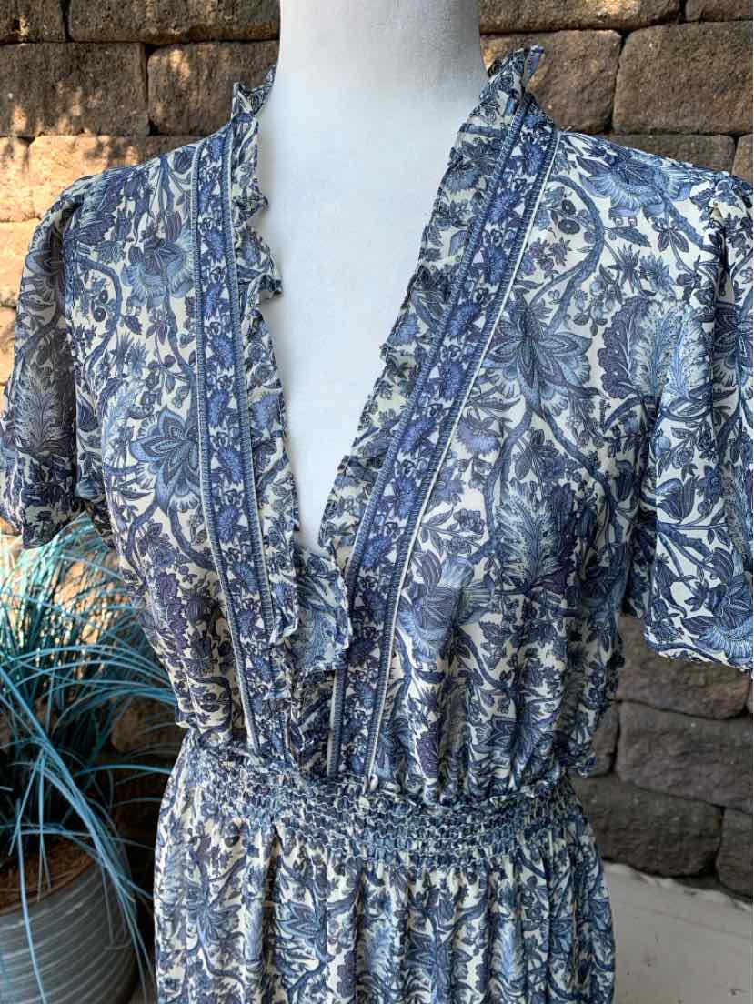 Blue floral maxi dress with V-neckline, ruched waist, and short sleeves on dress form.
