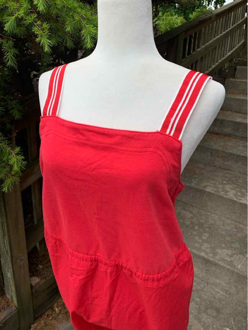 Red sleeveless tank top with double white stripes on straps and square neckline.