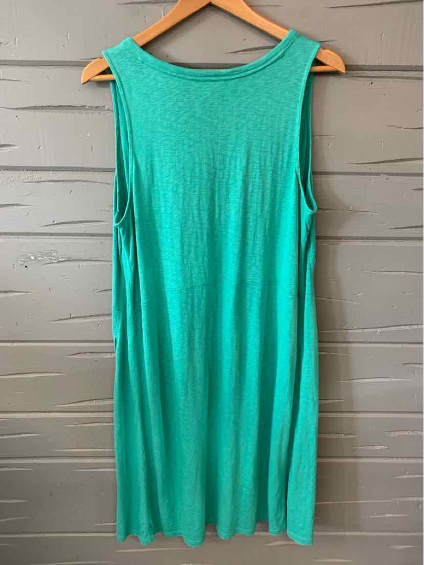 Sleeveless turquoise casual dress with scoop neckline, flowing knee-length fabric.