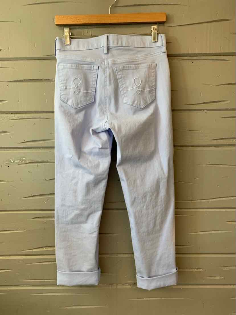 Light wash denim jeans with rolled cuffs and two back pockets on wooden hanger.