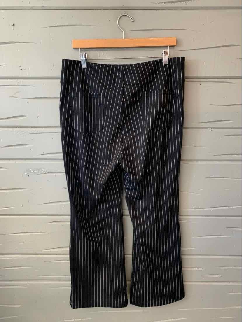 Black Halara trousers with narrow white vertical stripes, a straight-leg cut, and a gathered elastic waistband.