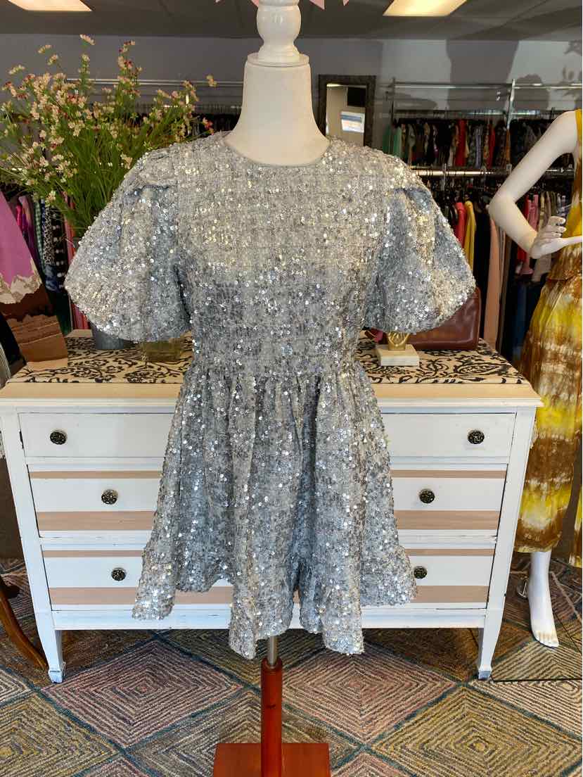 Light blue short-sleeve dress with floral lace overlay and cinched waist on white mannequin.