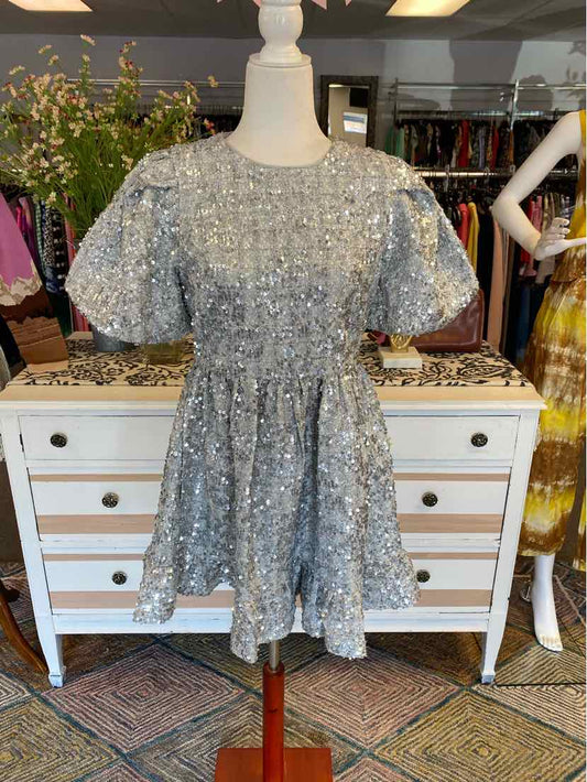 Light blue short-sleeve dress with floral lace overlay and cinched waist on white mannequin.