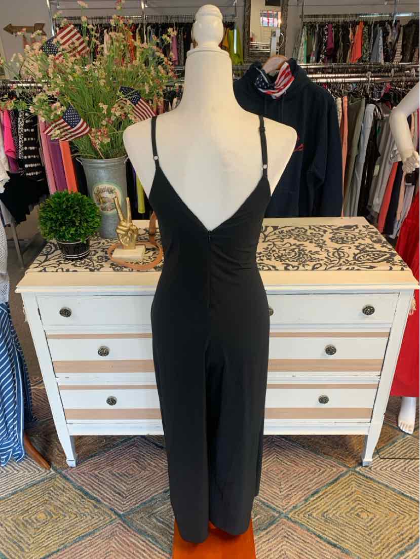 Black sleeveless jumpsuit with V-neck and fitted waist on mannequin.