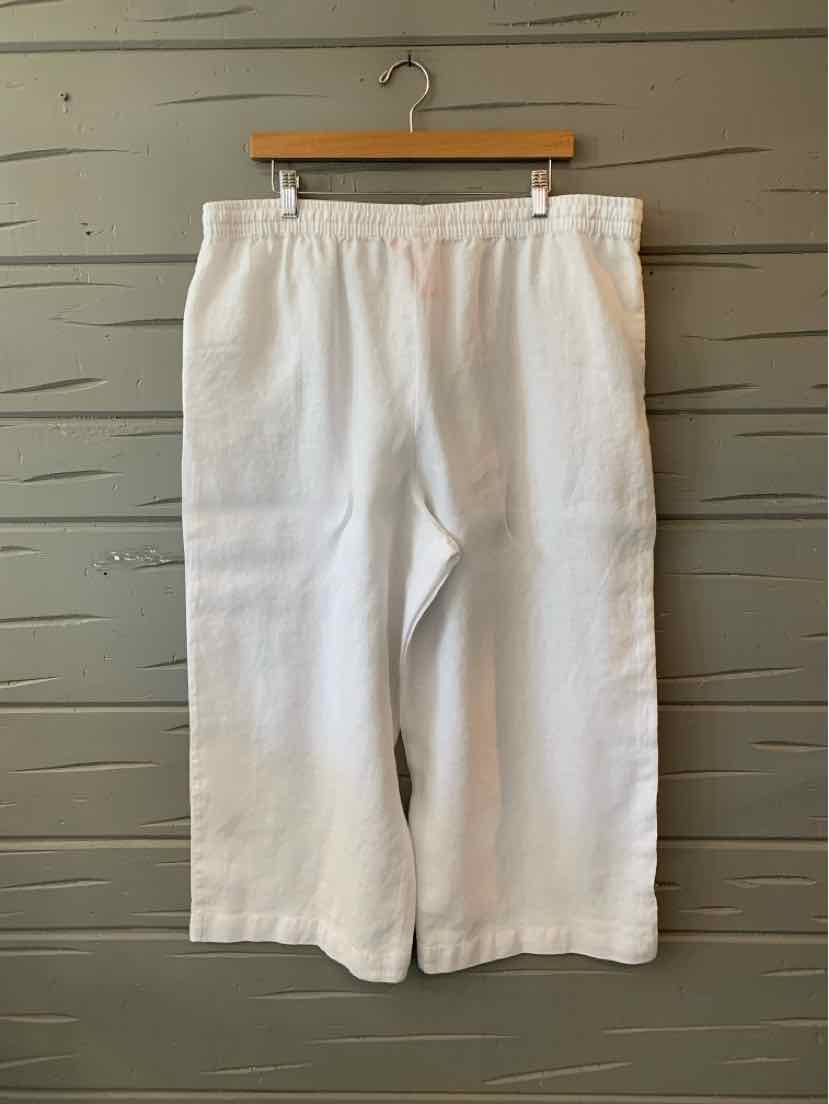White linen wide-leg pants with elastic waistband, size XL hanging on wooden hanger.