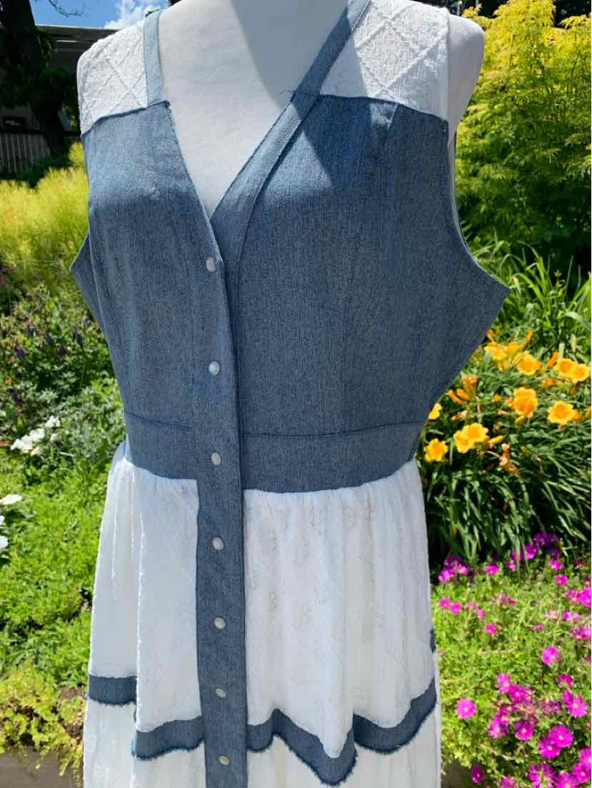 Sleeveless denim vest with buttons, V-neck, and white skirt with blue scalloped trim.