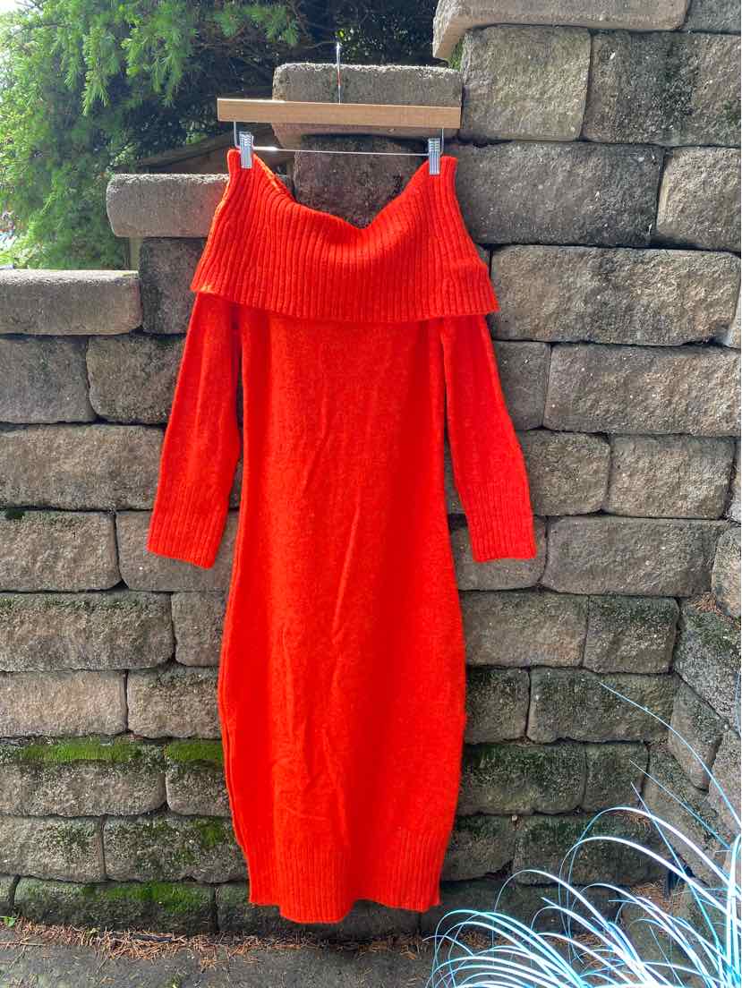 Bright orange long knit sweater dress with off-the-shoulder fold-over neckline and long sleeves.