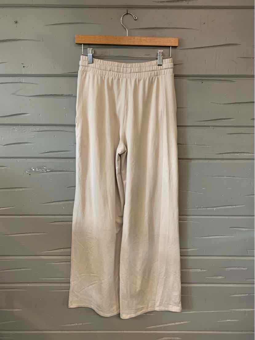 Light beige wide-leg pants with elastic waistband made from soft, flowy fabric.