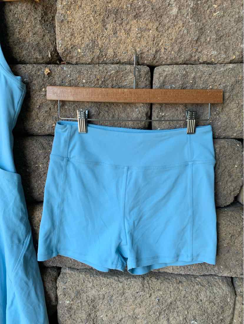 Light blue high-waisted athletic shorts with flat seams and a smooth, stretchy fabric panel front.