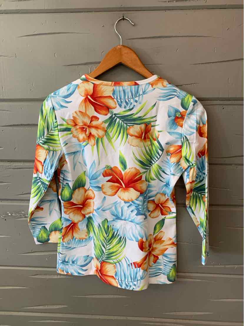 Long-sleeve tropical print shirt with orange and blue hibiscus flowers and green palm leaves on white background.