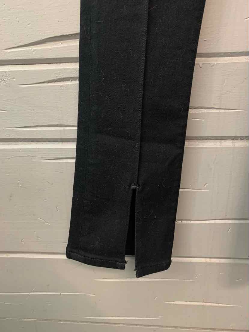 Black denim pants leg with a front slit at the hem, size 4.
