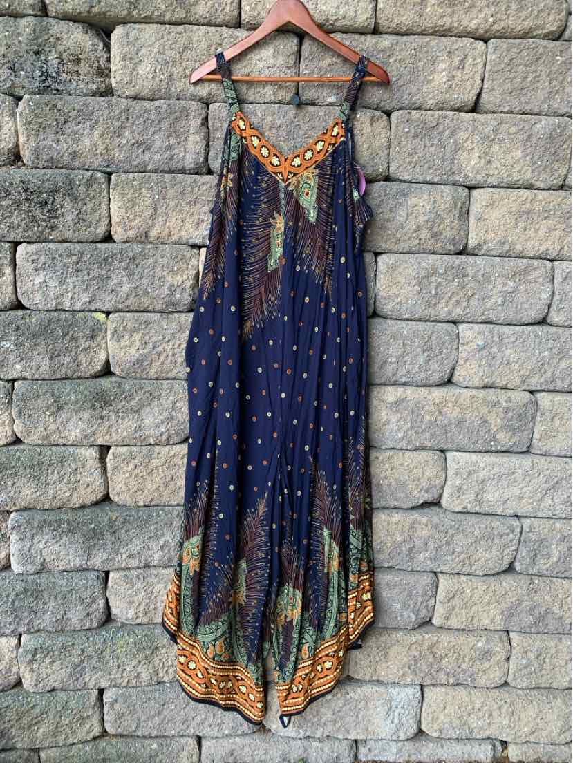 Navy blue sleeveless maxi dress with orange, green, and brown geometric patterns and thin shoulder straps.