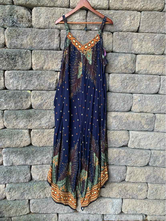 Navy blue sleeveless maxi dress with orange, green, and brown geometric patterns and thin shoulder straps.