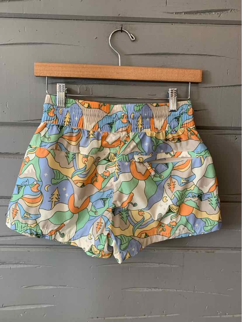 High-waist shorts with colorful abstract print in orange, green, blue, and white, featuring elastic waistband and pockets.