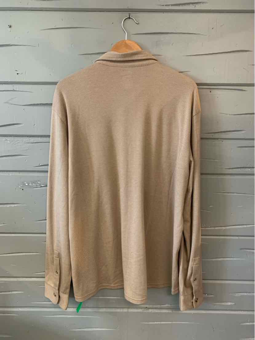Tan long-sleeve polo shirt in XXL with a soft, smooth fabric and ribbed cuffs hanging on wooden hanger against a gray wood.