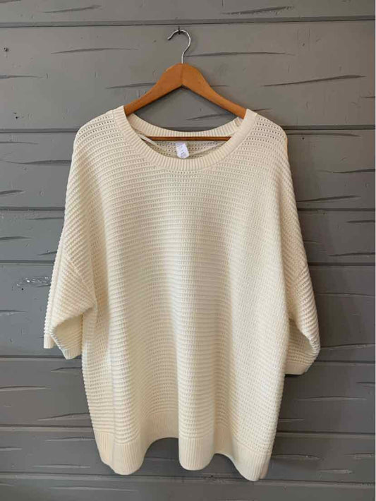 Cream ribbed knit casual top for women with loose sleeves and crew neckline.