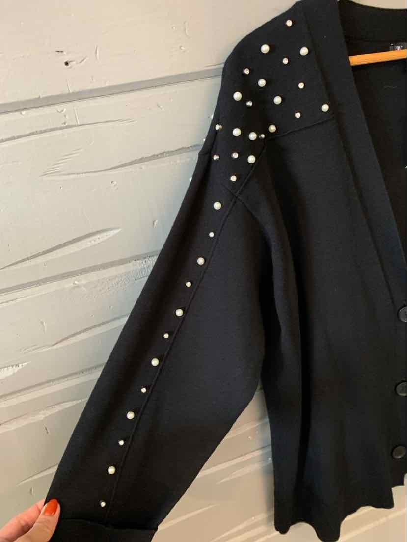 Black long-sleeve cardigan with front buttons and pearl embellishments on the shoulders and sleeves.