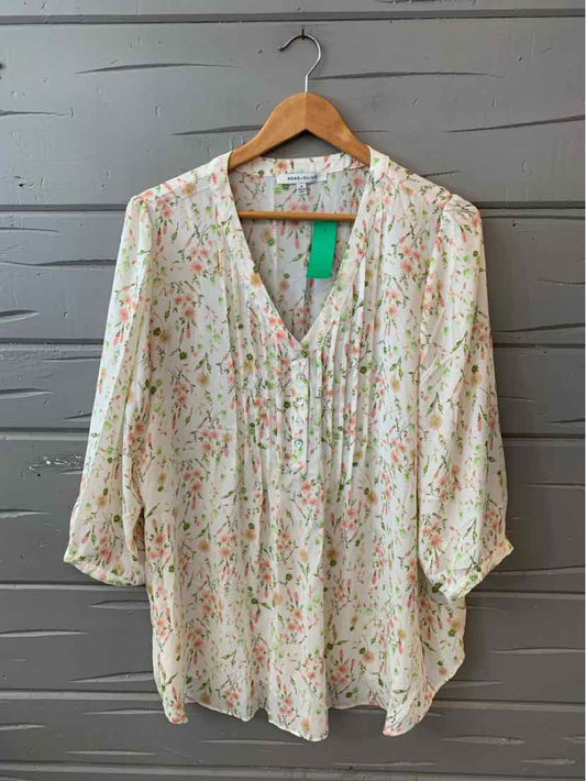 White blouse with pink and olive floral print, V-neck, and 3/4 balloon sleeves, size 1X.