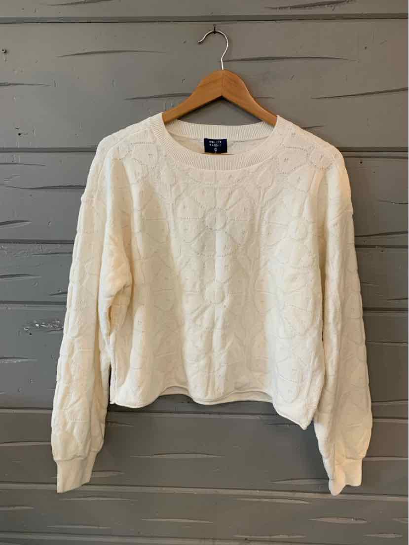 White cable-knit long-sleeve sweater with floral knit pattern, crew neck, and ribbed cuffs.