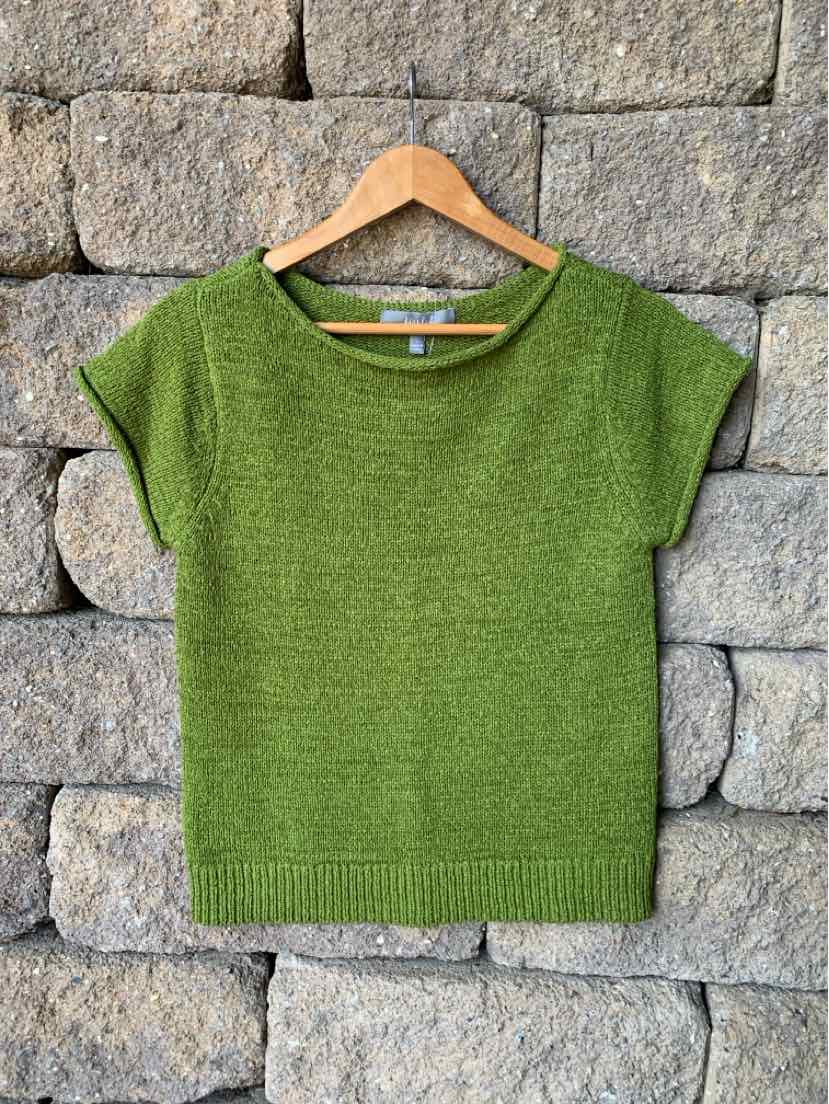 Green marled knit short-sleeve sweater with ribbed hem on wooden hanger.