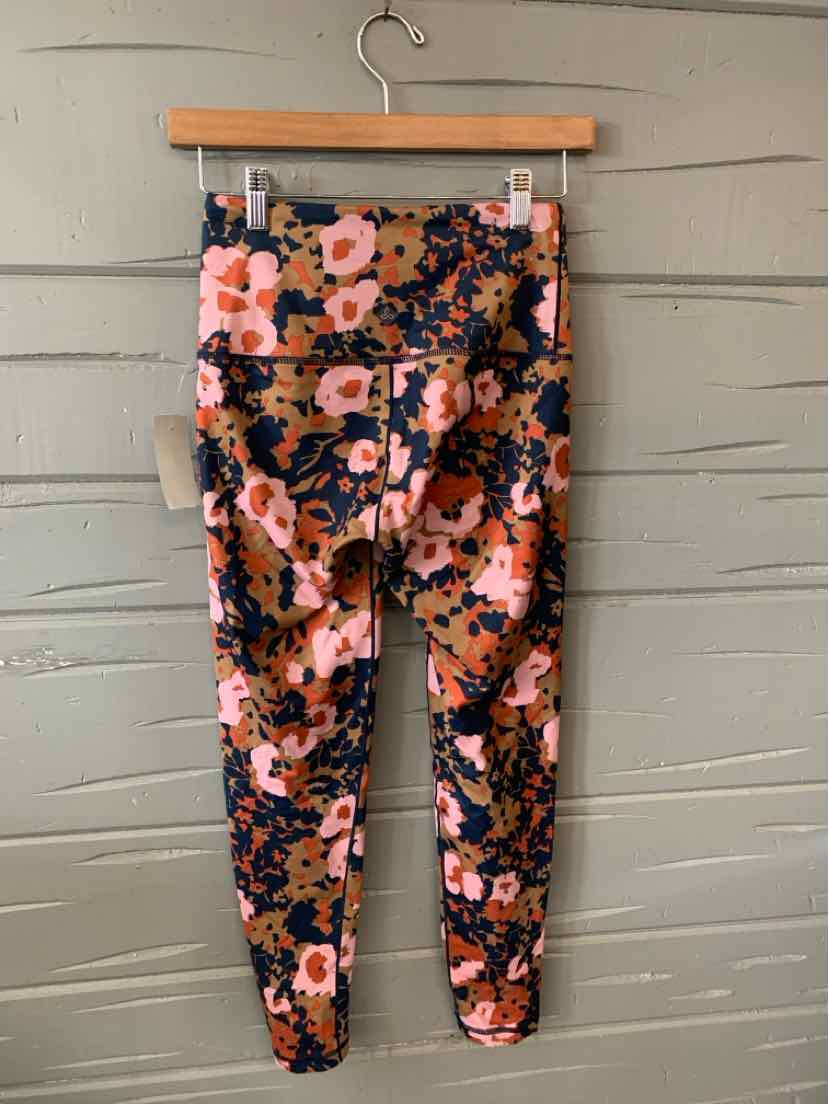 Floral-patterned leggings in pink, navy, and orange with a fitted silhouette and high waist.