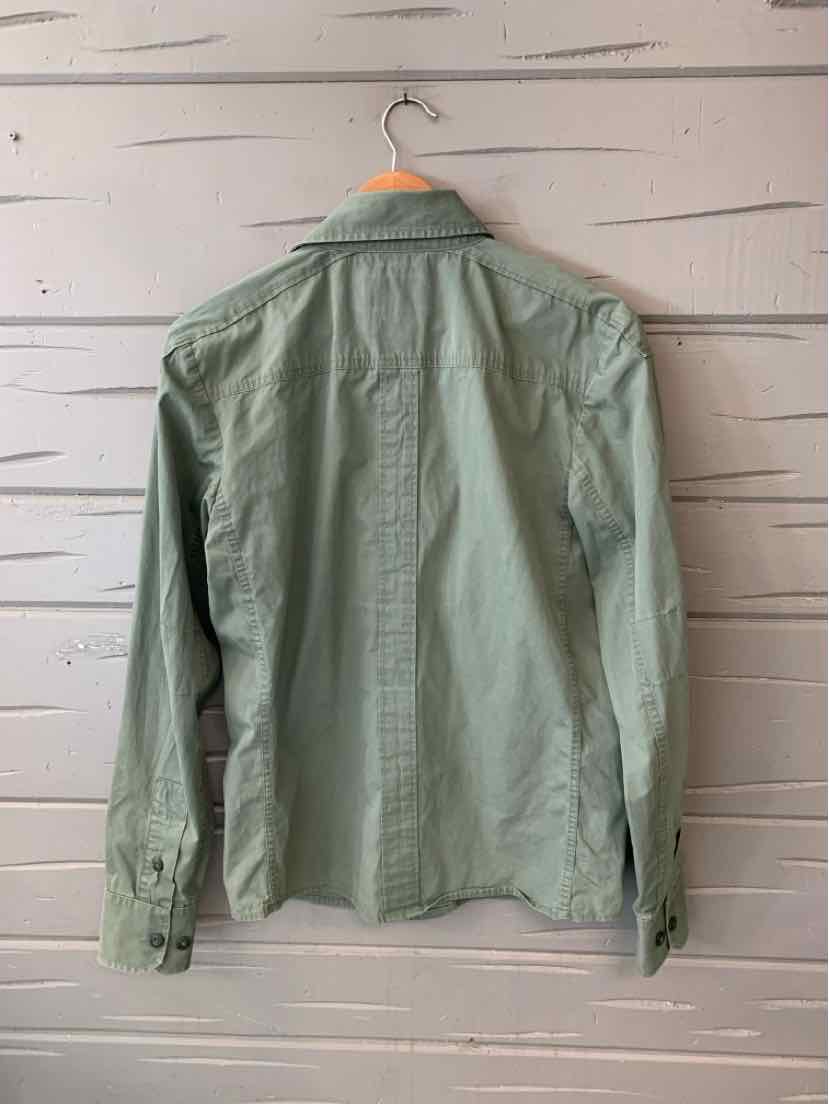 Light green long-sleeve button-up shirt with a classic collar hanging on a wooden hanger.