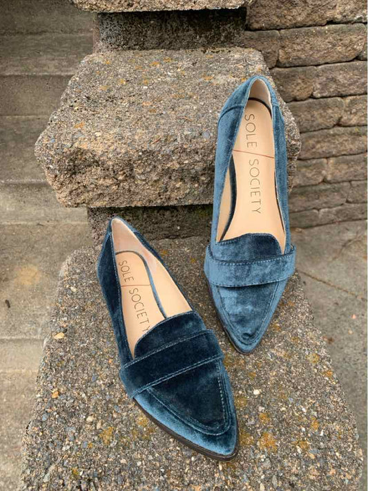 Women's velvet loafers in deep blue with pointed toes and low heels.