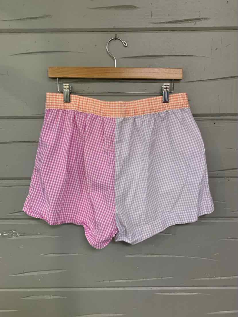 Two-tone gingham shorts with pink and white sections and a peach plaid elastic waistband.