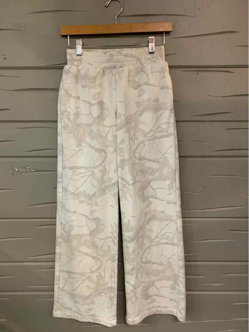 High-waisted wide-leg pants with a subtle beige and cream abstract pattern and a front center slit.