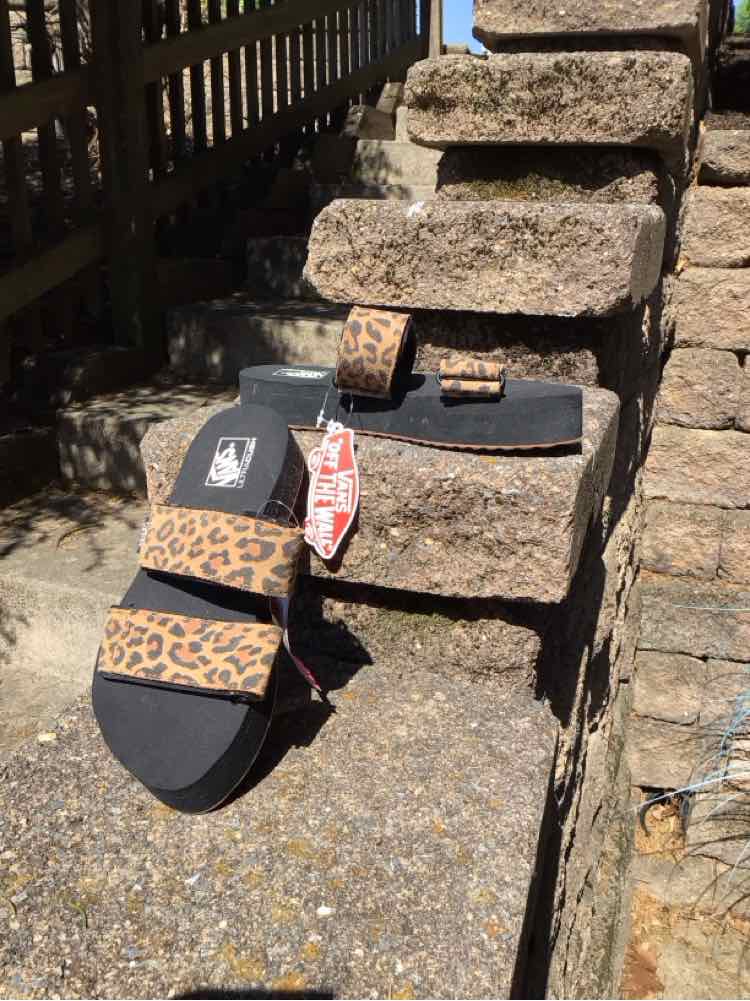 Tan Vans women's sandal with black sole and cheetah print straps, size 6.