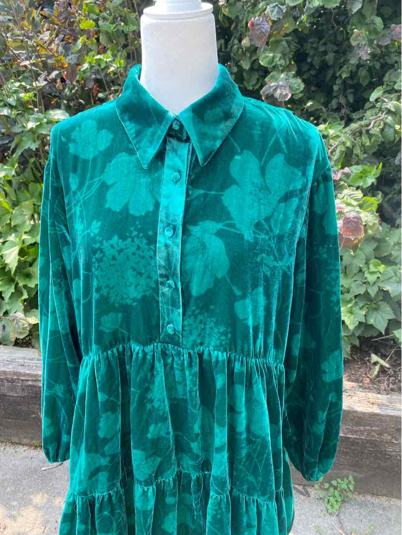 Green long-sleeve blouse with floral pattern, button-up front, and gathered waist in medium size.