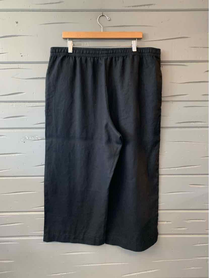 Black linen wide-leg pants with elastic waistband in size XL hanging on wooden hanger.