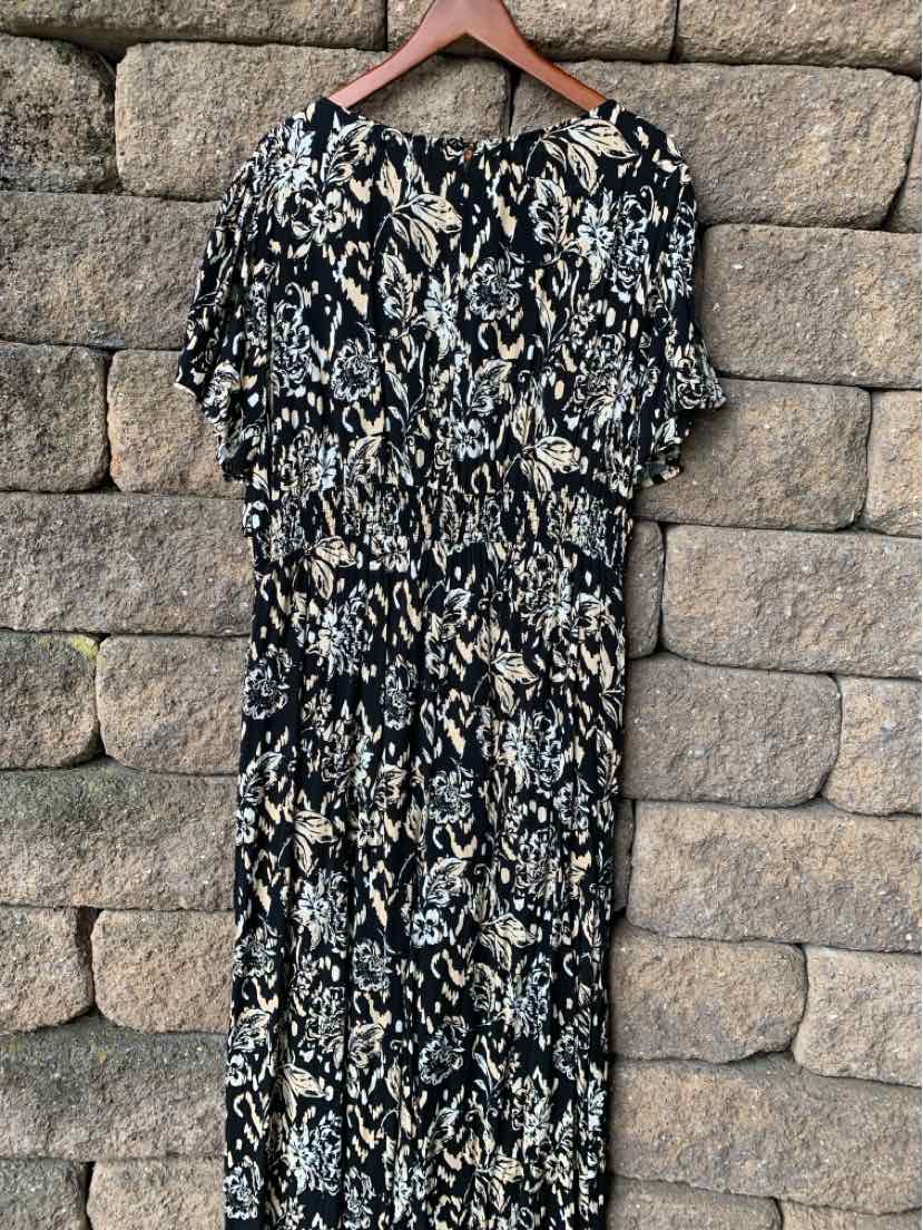 Black and white patterned short-sleeve dress with cinched waist and knee-length hem.