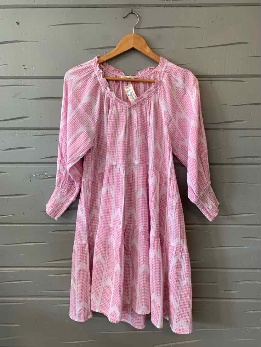 Pink long-sleeve midi dress with white geometric print, gathered neckline, and lightweight fabric.