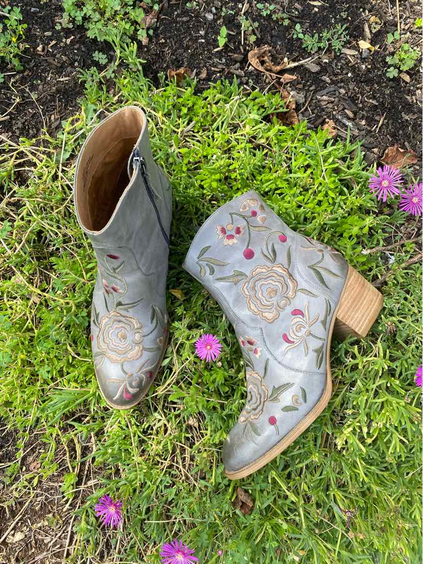Gray ankle boots with floral embroidery, rounded toes, and stacked wooden heels.