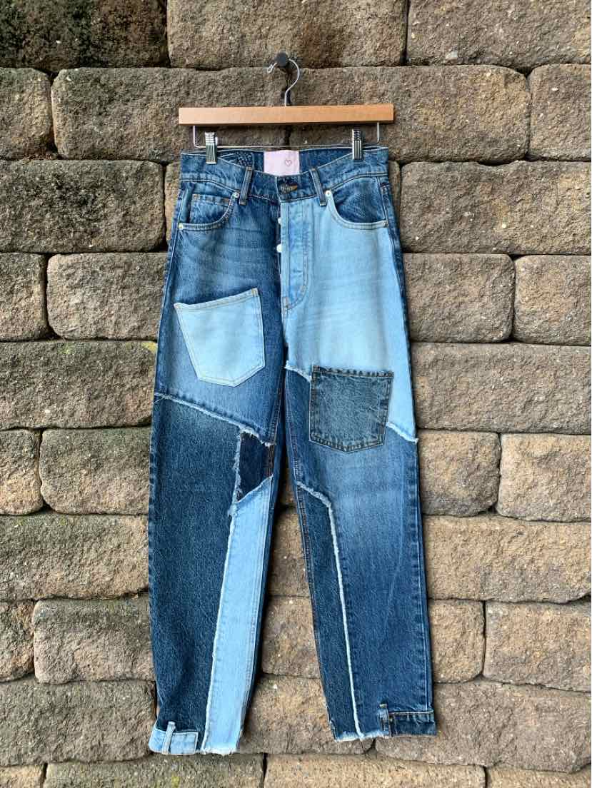 Patchwork slim-fit jeans in various blue denim shades with contrast stitching and multiple fabric textures.