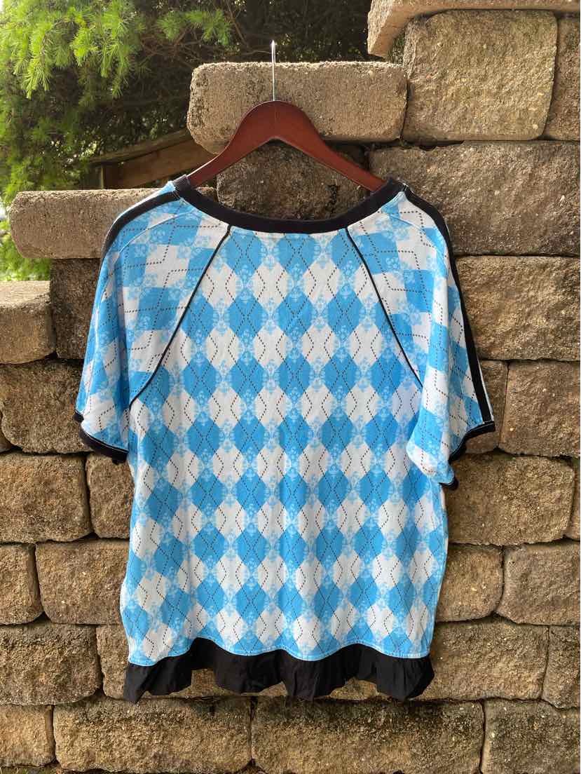 Blue and white argyle pattern short-sleeve blouse with black trim and hem.