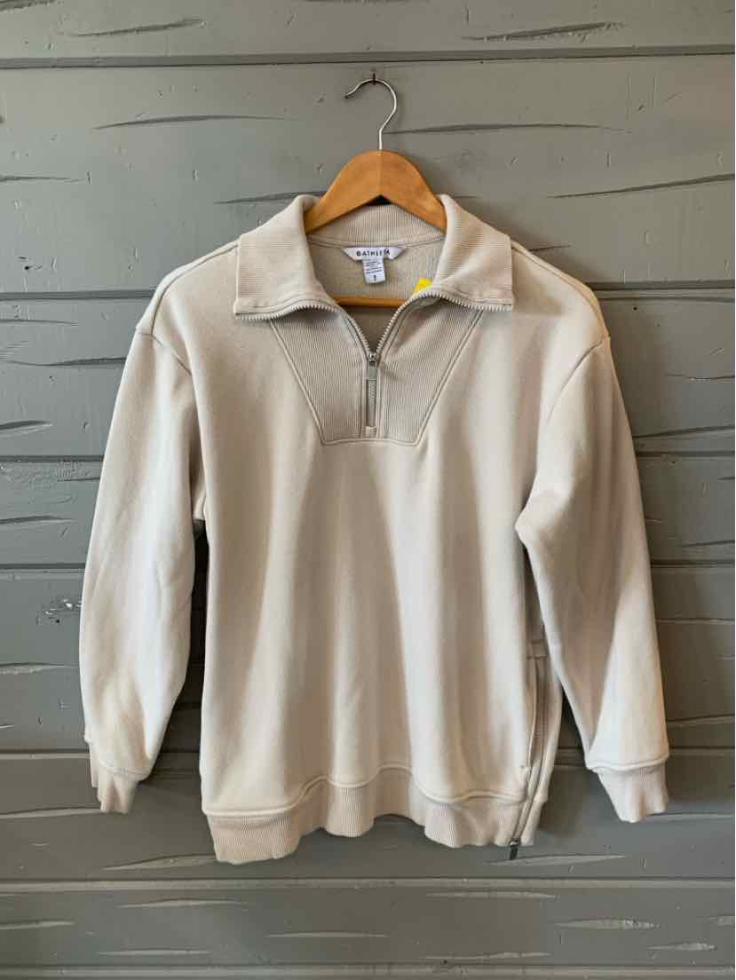 Tan quarter-zip pullover with long sleeves and ribbed cuffs, relaxed fit, on wooden hanger.