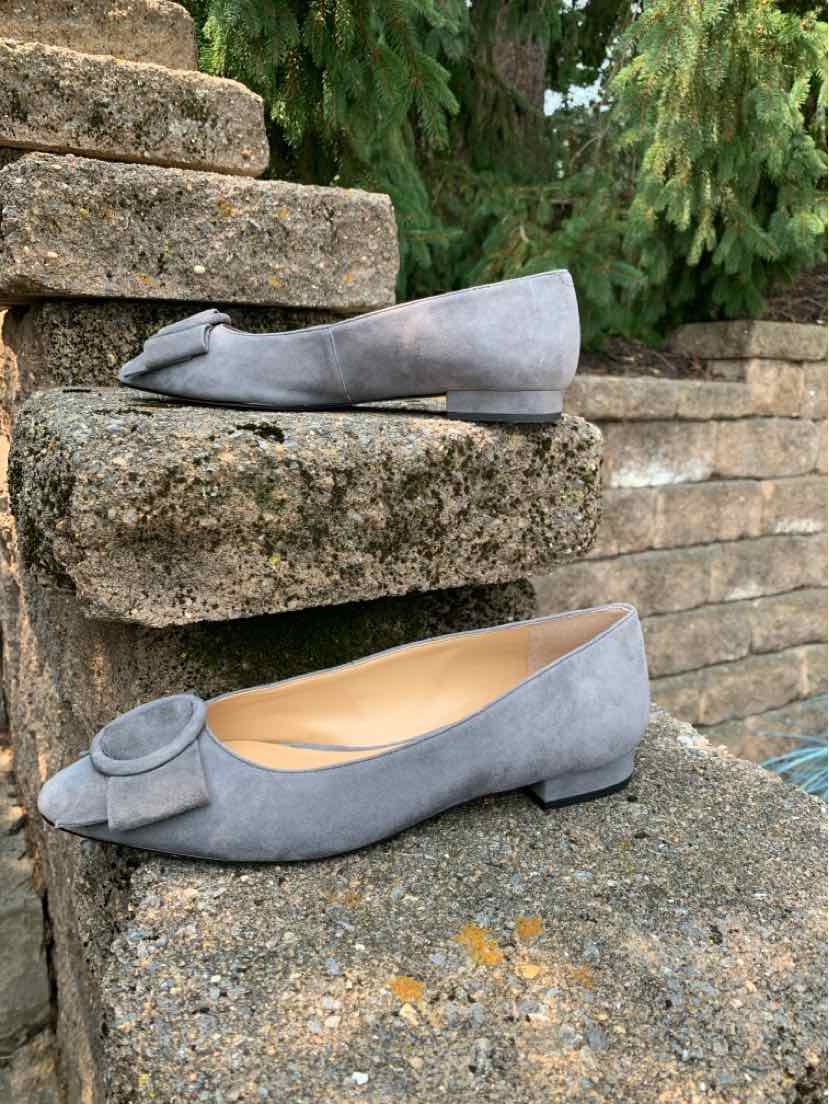 Gray suede ballet flats with a rounded toe and decorative bow on top, size 7.