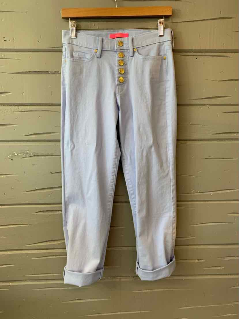 Light wash denim jeans with rolled cuffs and four exposed gold buttons on the front fly.