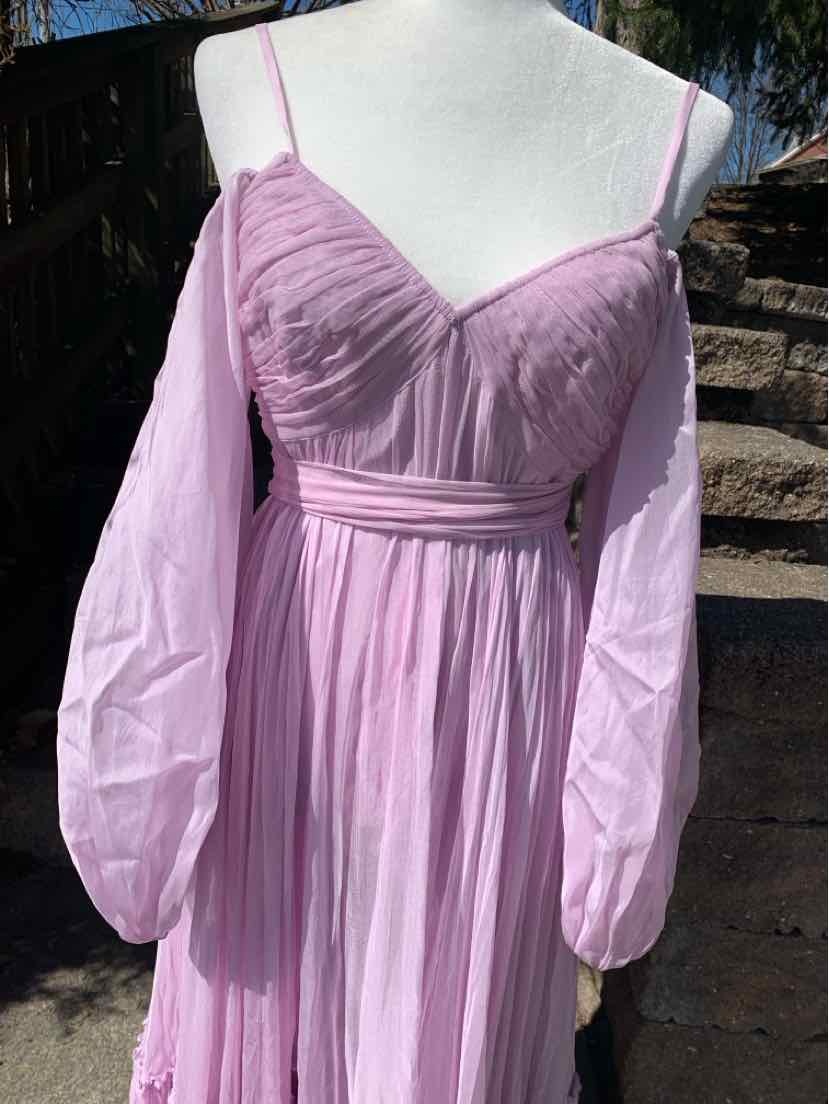 Lavender off-shoulder dress with sheer long sleeves and ruched bodice on mannequin.
