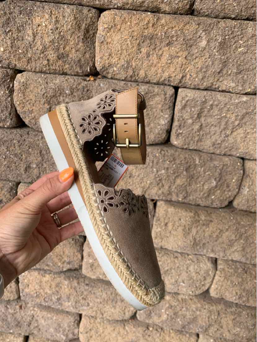 Taupe suede espadrille wedge sandal with floral cutouts and an ankle strap buckle.