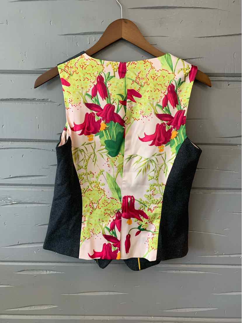 Sleeveless floral print women's vest with green, pink, and yellow flowers and black side panels.
