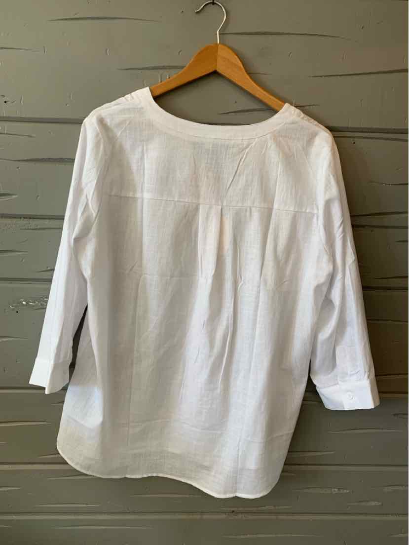 White long-sleeve blouse with round neckline and relaxed fit on wooden hanger.