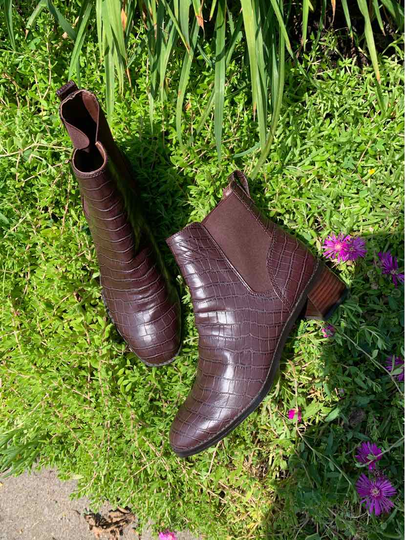 Brown leather ankle boots with pointed toes and elastic side panels, low stacked heels.