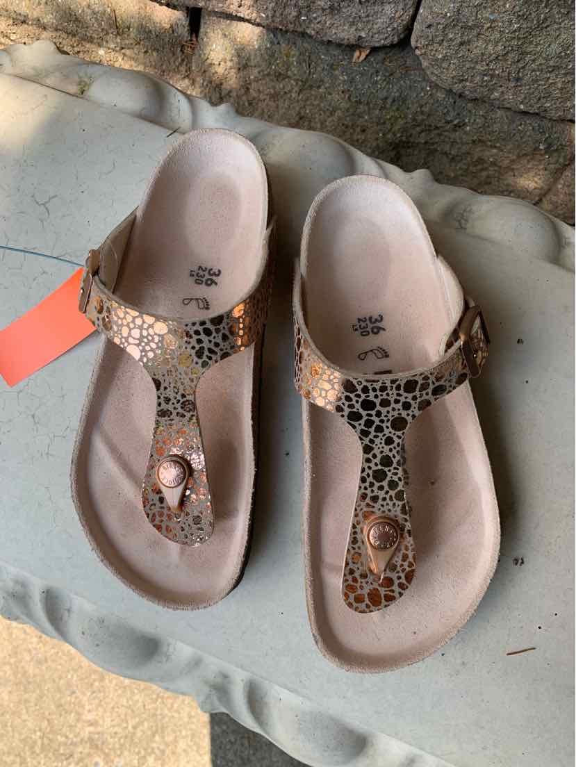 Women’s size 36 Birkenstock sandals with brown leopard print straps and cork footbeds.