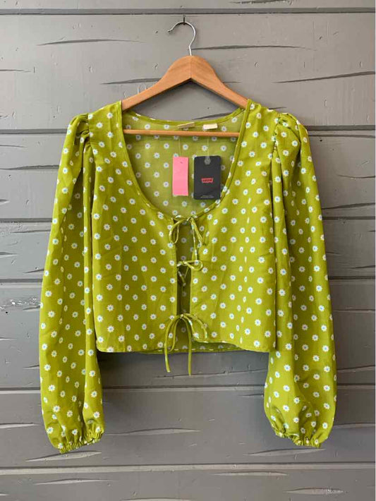 Green long-sleeve blouse with white polka dots, square neckline, and front tie detail.