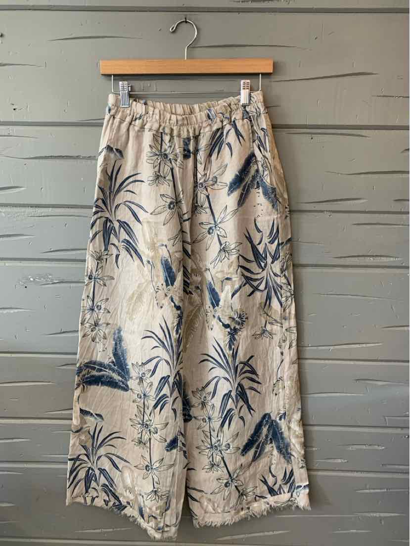 Tan lightweight tropical print wide-leg pants with elastic waistband and side pockets, size L/XL.